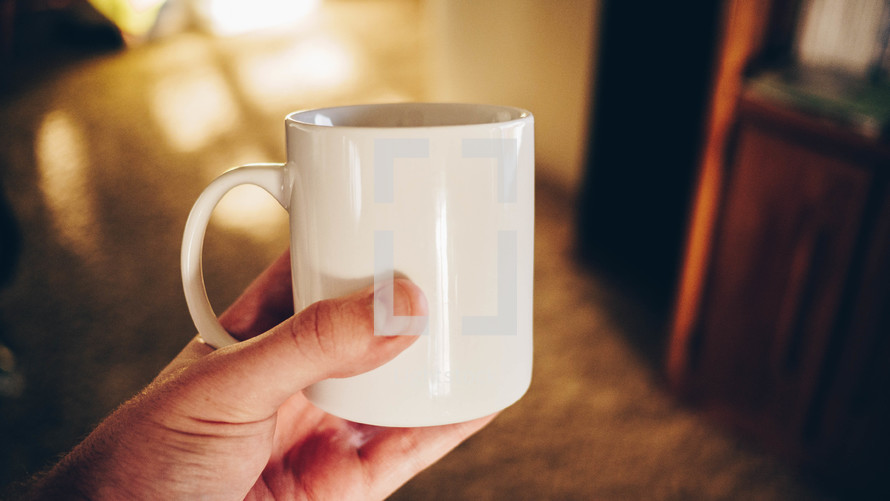 a man holding a coffee mug 