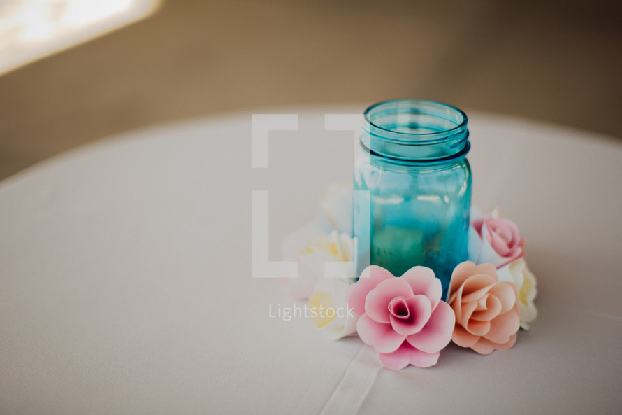 flowers around a blue mason jar 