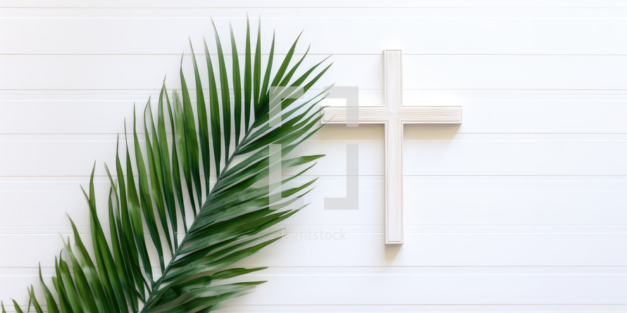 Palm Sunday. Cross and palm leaf on white wooden wall background