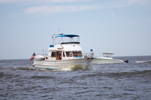 Luxury boats traveling through Lake Michigan at Grand Haven State Park in Grand Haven, Michigan, western Michigan, Great Lakes