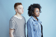 headshot of two young adults staring off into space 