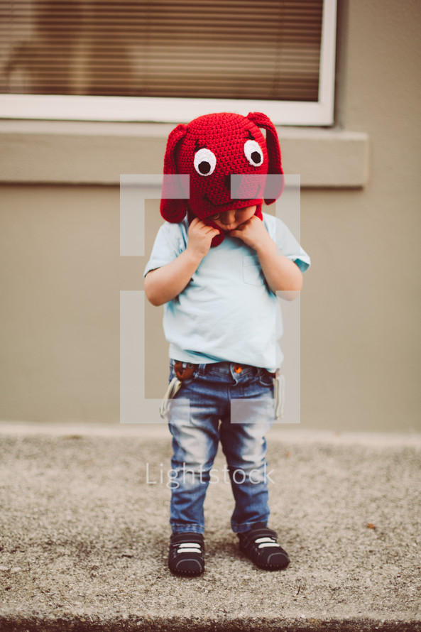 toddler boy in a red dog knit hat 