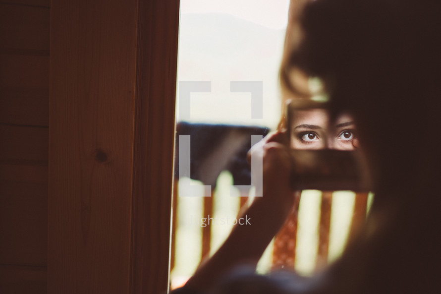 a woman looking into a mirror 