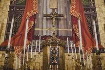 A holy altar with candelabras and a crucifix
