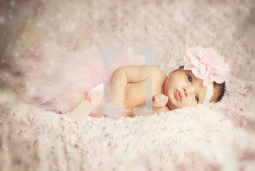 Newborn baby girl wearing a pink ballerina tutu