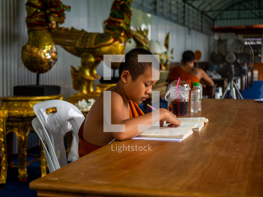 child student working at a table 