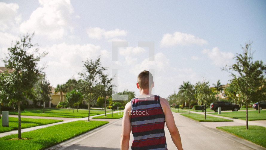 a man walking down a neighborhood street 