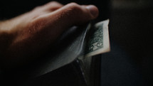 dollar bill bookmark in a Bible 