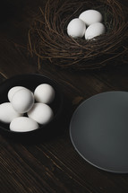 Easter eggs and bird nest on a rustic wooden table
