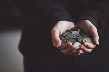 cupped hands holding coins 