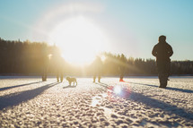 Sunset light on people playing in the snow