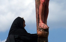 Mary weeping at the feet of Jesus at his crucifixion on the cross at Golgotha, the place of the Cross. 