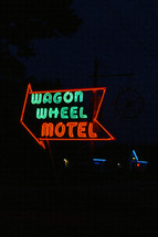 wagon wheel motel neon sign at night 