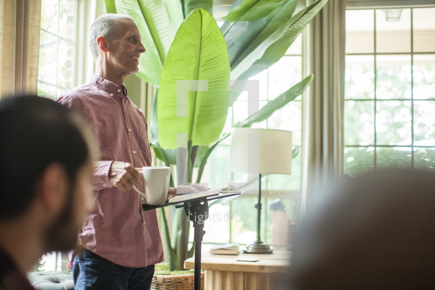 man leading a discussion at a home Bible study 