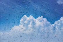 drops on the window and cloud sky background