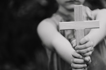 a child holding a cross