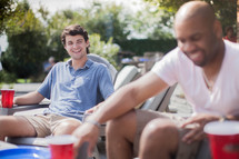 friends talking at a backyard summer party