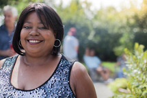 Headshot of an African American woman at an outdoor summer party 