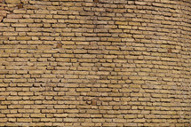Tan brick wall made from hand made bricks