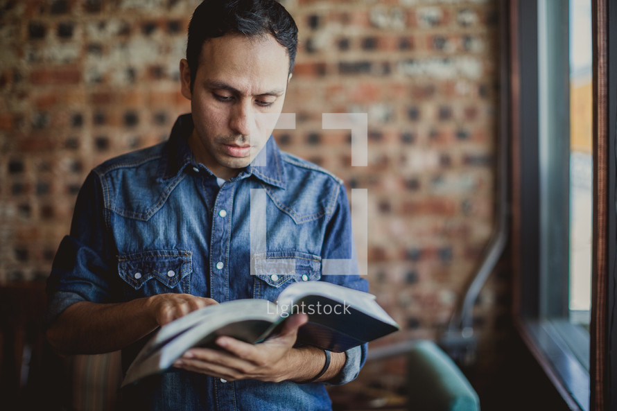 Latino man reading a Bible 