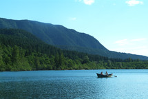Rowing a boar on a mountain side  lake