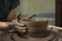 potter forming clay 