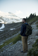 a man backpacking through mountain landscape 
