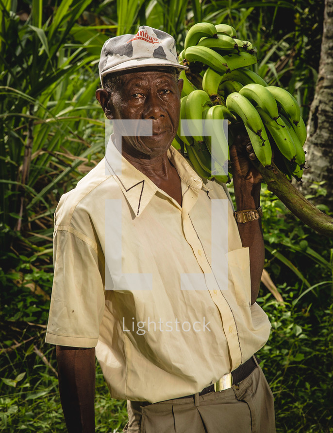 a man holding a bunch of bananas 