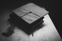 a Bible and Graduation cap