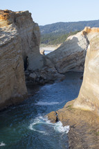 swirling sea water between rock cliffs 