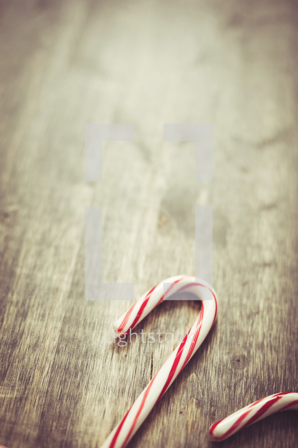 candy canes on wood background 