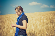 Girl standing in a wheat field.