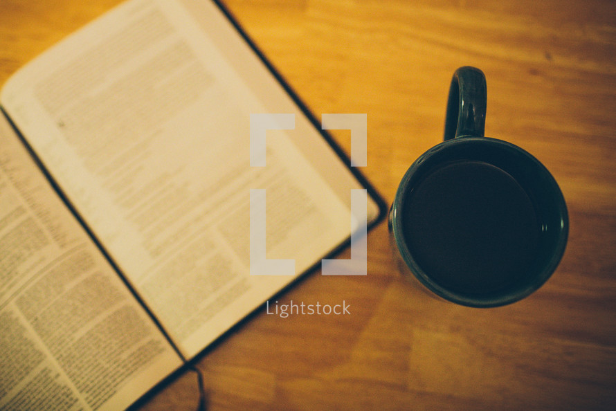 open Bible and a coffee mug