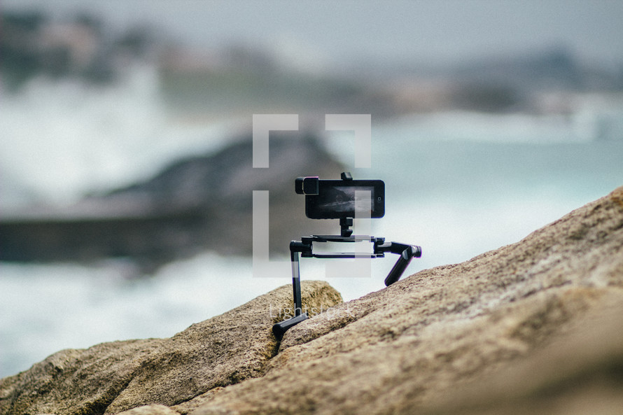 camera on a tripod on rocks 