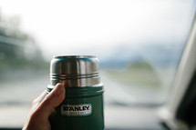 hand holding a coffee canister 
