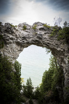 view of ocean through a rock arch 