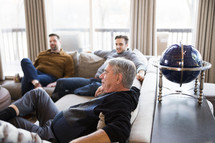 men sitting on a couch 