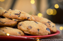 chocolate chip cookies on a plate and bokeh lights 
