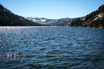 Open lake between snow-covered mountains.