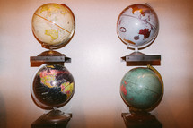 Globes mounted on a wall.