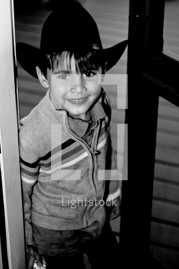 smiling boy child in a cowboy hat