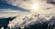 Misty alps mountains with foggy clouds motion fast in sunny spring nature timelapse
