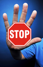 man with stop sign on his hand