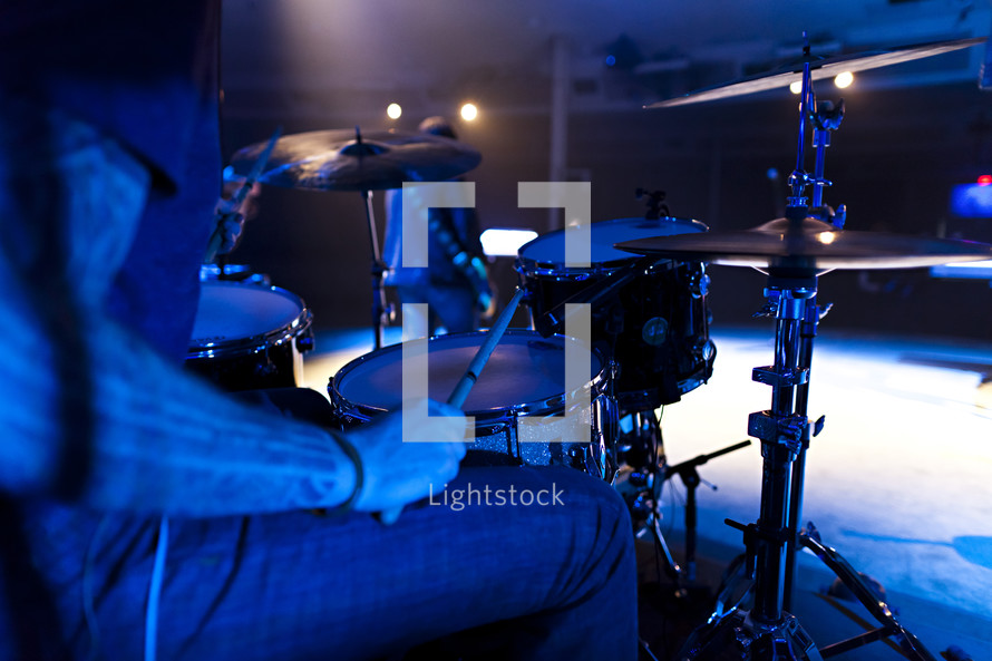 A drummer and drum set kit sticks cymbals snare 