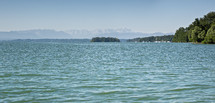 distant view of the Alps and lake water 