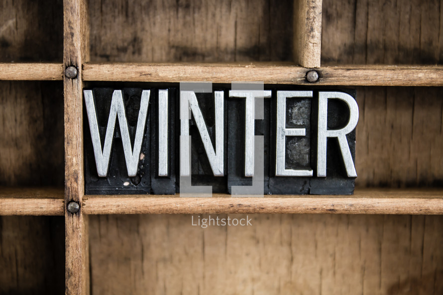 word winter in blocks on a shelf 