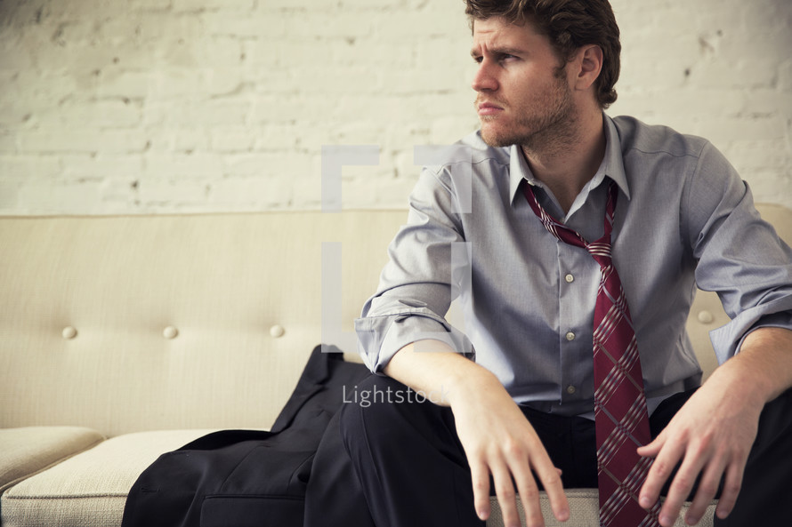 a businessman sitting on a couch 