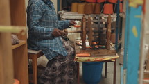 Woman hand spinning thread on a spindle