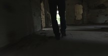 man walking out of an abandoned building 