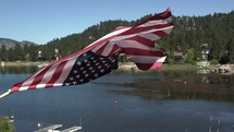 American flag waving over a lake 